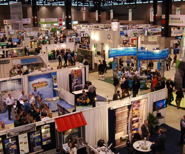 birds eye view of a Conference Floor with dozens of people looking around