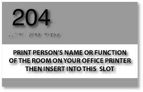 Gray and white name sign example with a room number above it